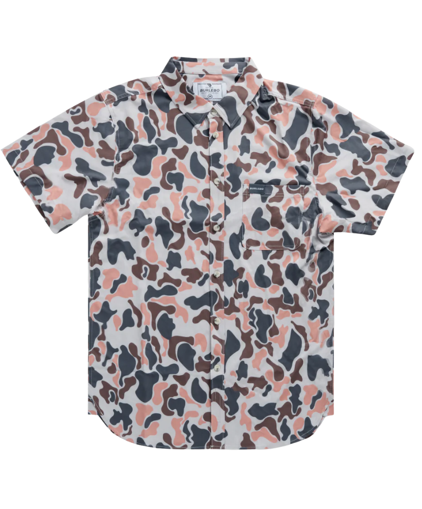 Man wearing a vintage camo patterned short-sleeve button down shirt on a white background