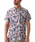 Man wearing a vintage camo patterned short-sleeve button down shirt on a white background