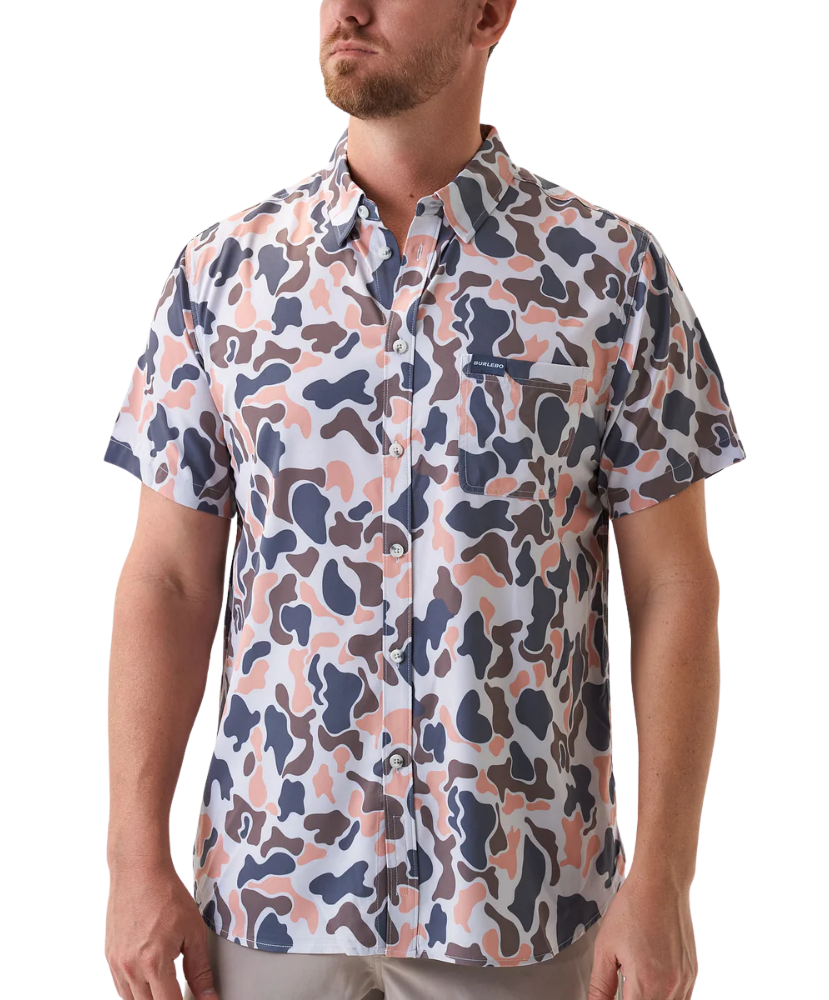 Man wearing a vintage camo patterned short-sleeve button down shirt on a white background