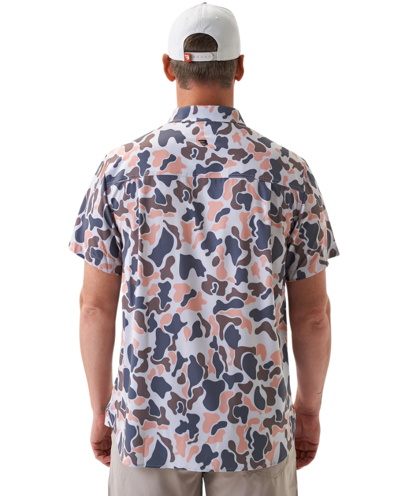 Man wearing a vintage camo patterned short-sleeve button down shirt on a white background