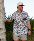 Man wearing a vintage camo patterned short-sleeve button down shirt on a white background