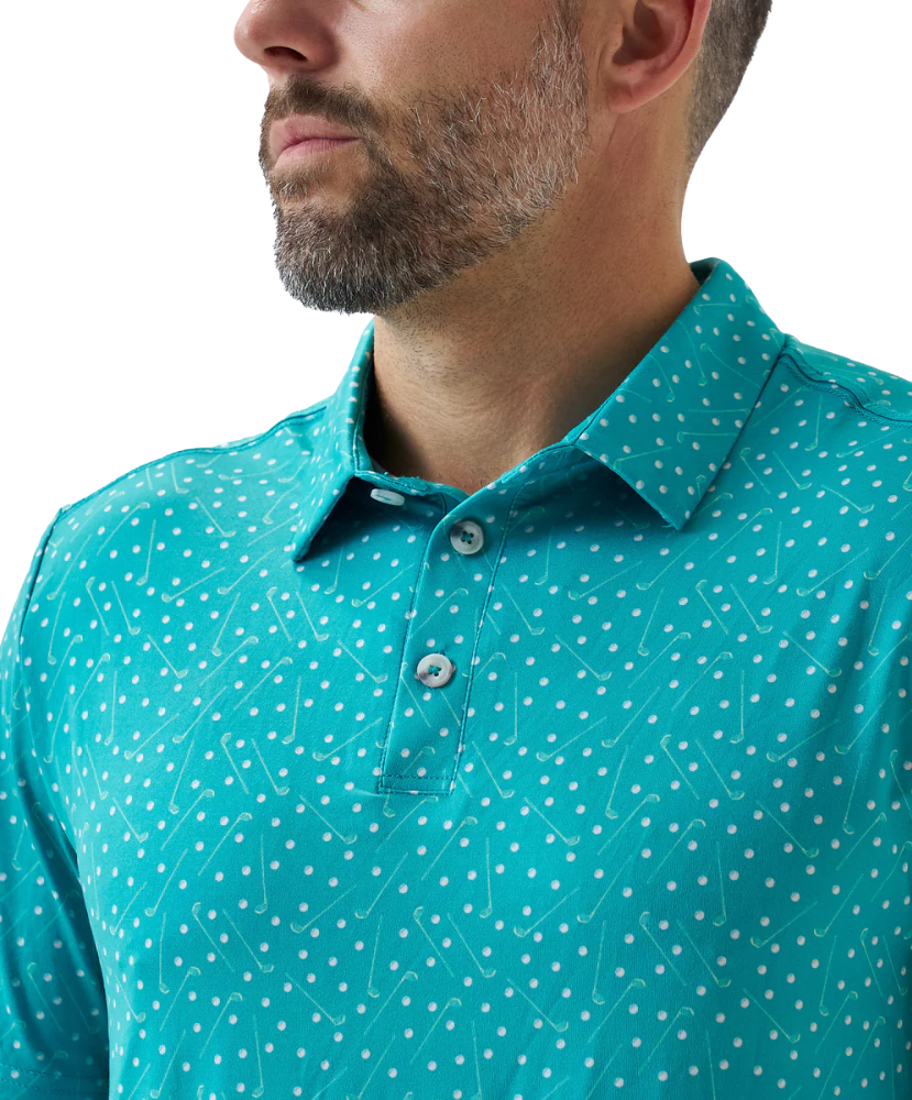 Man wearing a teal golf club and golf ball  dot polo shirt on a white background