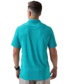 Man wearing a teal golf club and golf ball  dot polo shirt on a white background