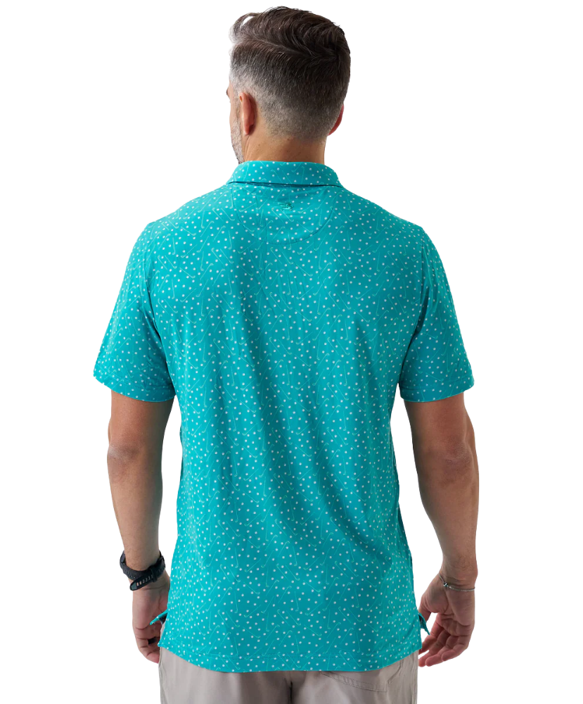 Man wearing a teal golf club and golf ball  dot polo shirt on a white background