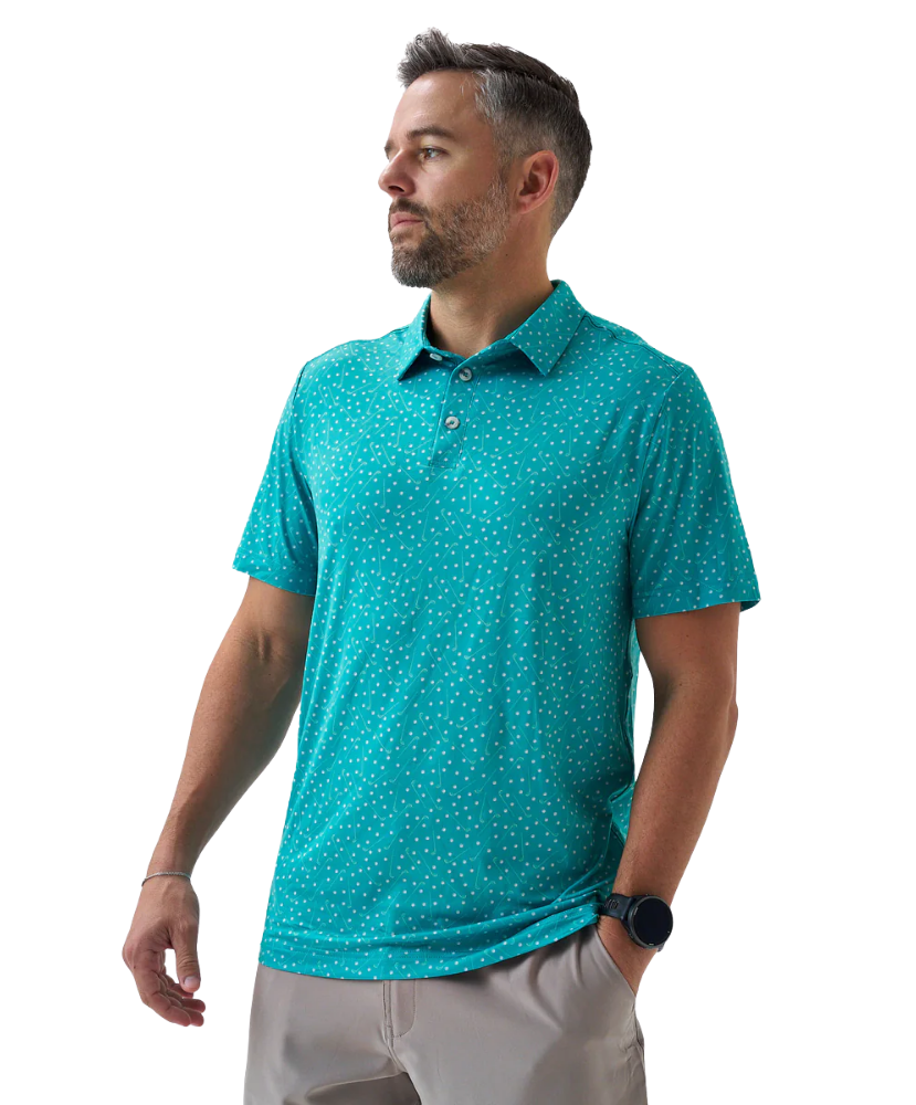 Man wearing a teal golf club and golf ball  dot polo shirt on a white background