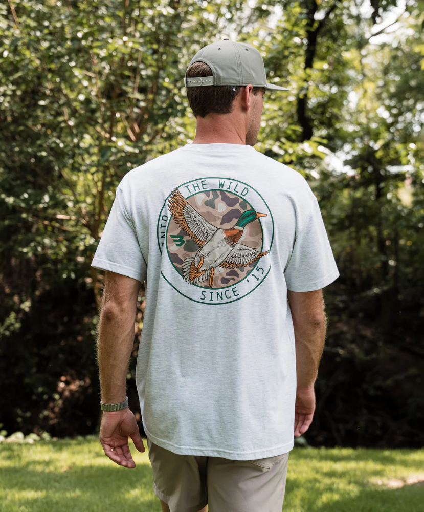 Gray Burlebo t-shirt with a mallard duck graphic and text on the back, worn by a person.