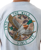 Gray Burlebo t-shirt with a mallard duck graphic and text on the back, worn by a person.