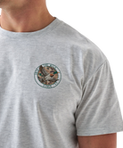 Gray Burlebo t-shirt with a mallard duck graphic and text on the back, worn by a person.