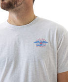 Gray t-shirt with a logo on the chest against a white background
