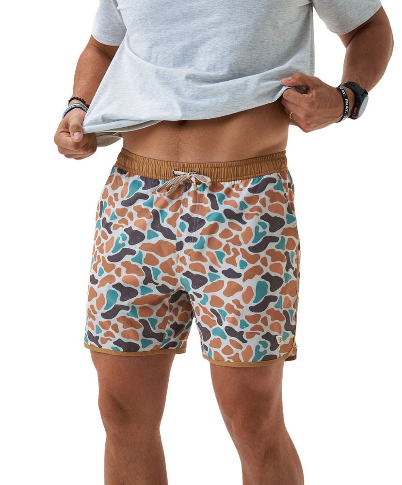 Person wearing CAMO patterned swim shorts on a white background