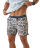 Person wearing camouflage SWIM shorts on a white background