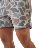 Person wearing camouflage SWIM shorts on a white background