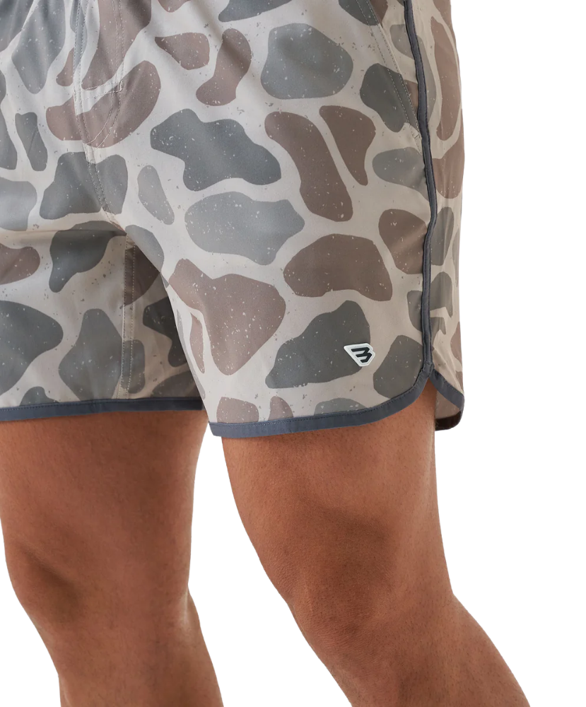 Person wearing camouflage SWIM shorts on a white background