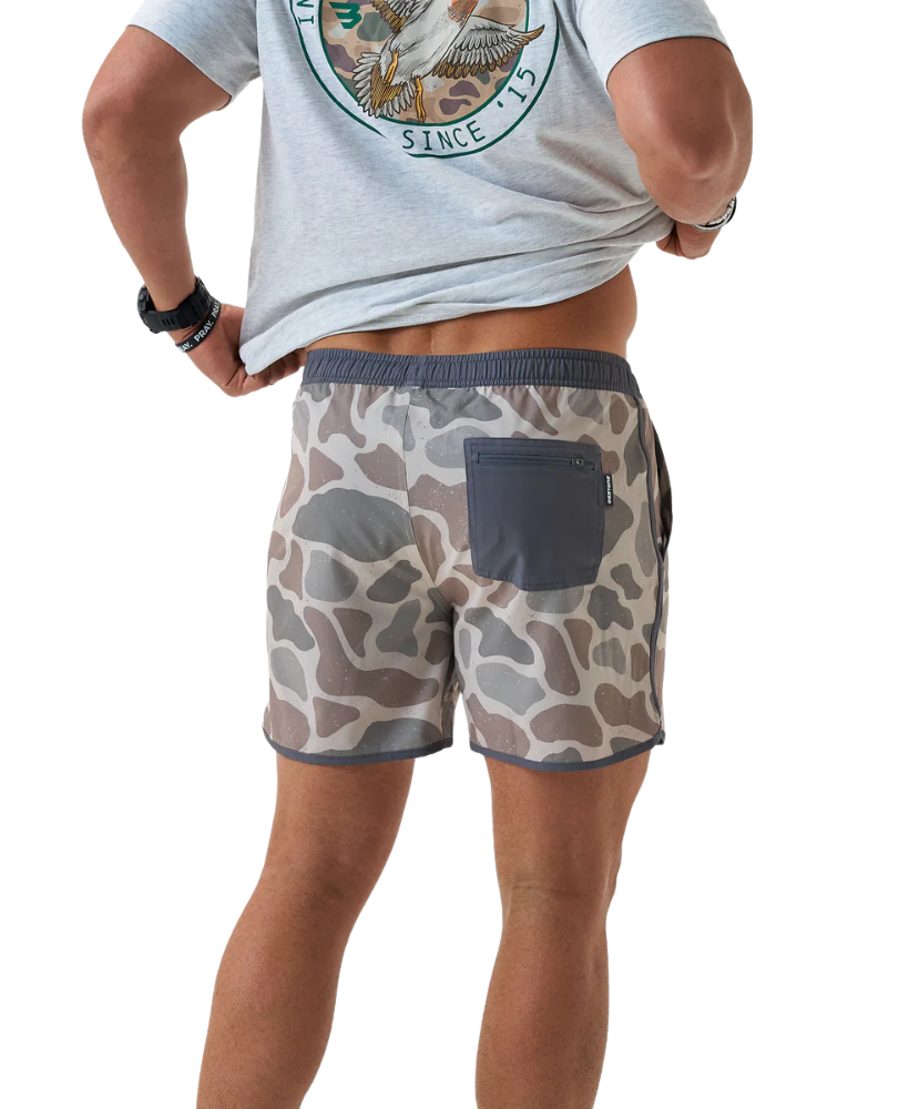 Person wearing camouflage SWIM shorts on a white background