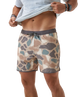 Person wearing camouflage swim shorts on a white background