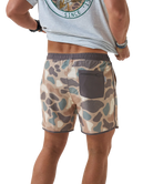 Person wearing camouflage swim shorts on a white background