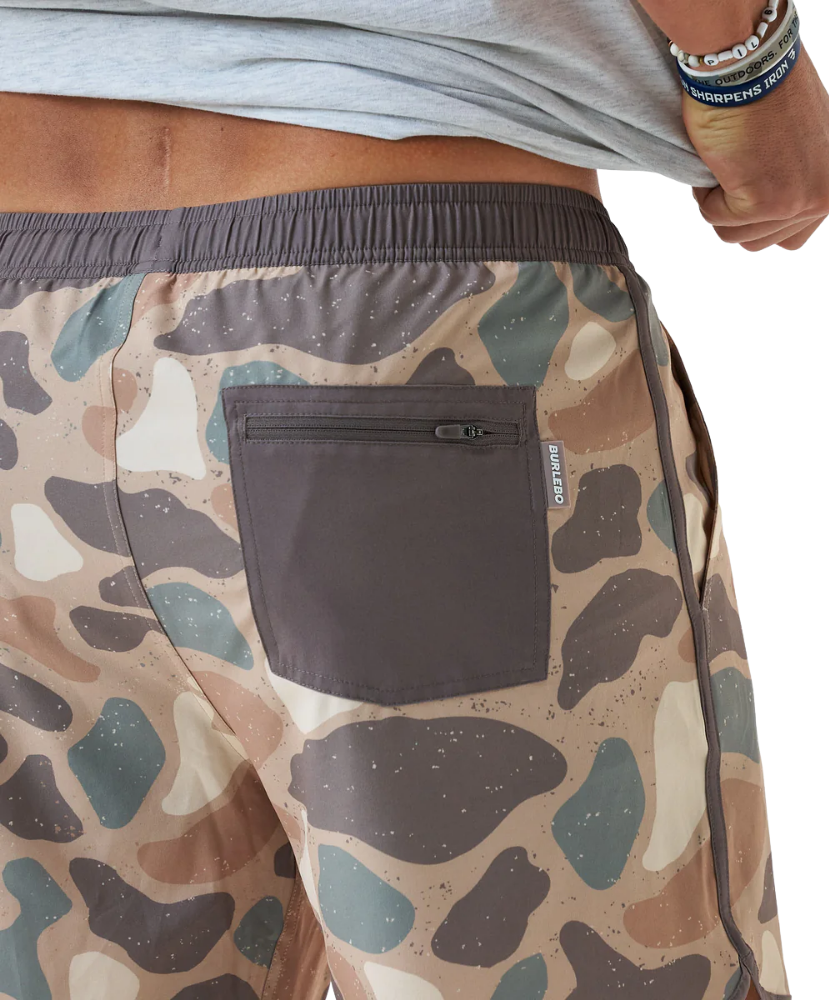 Camouflage-patterned swim shorts with a pocket and visible brand logo.