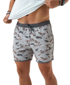Person wearing camouflage swim shorts on a white background