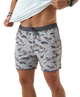 Person wearing camouflage swim shorts on a white background