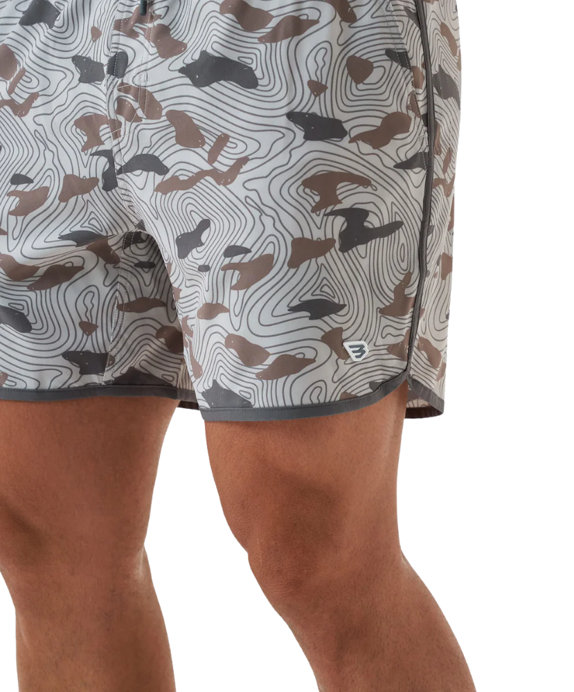 Person wearing camouflage swim shorts on a white background
