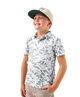 Child wearing a CAMO patterned polo shirt and cap on a white background