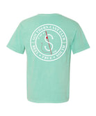 A mint green short-sleeve t-shirt shown from the back, featuring a large white circular graphic with a compass and red line details, and the text 'SOUTHERN CAST CLUB'.