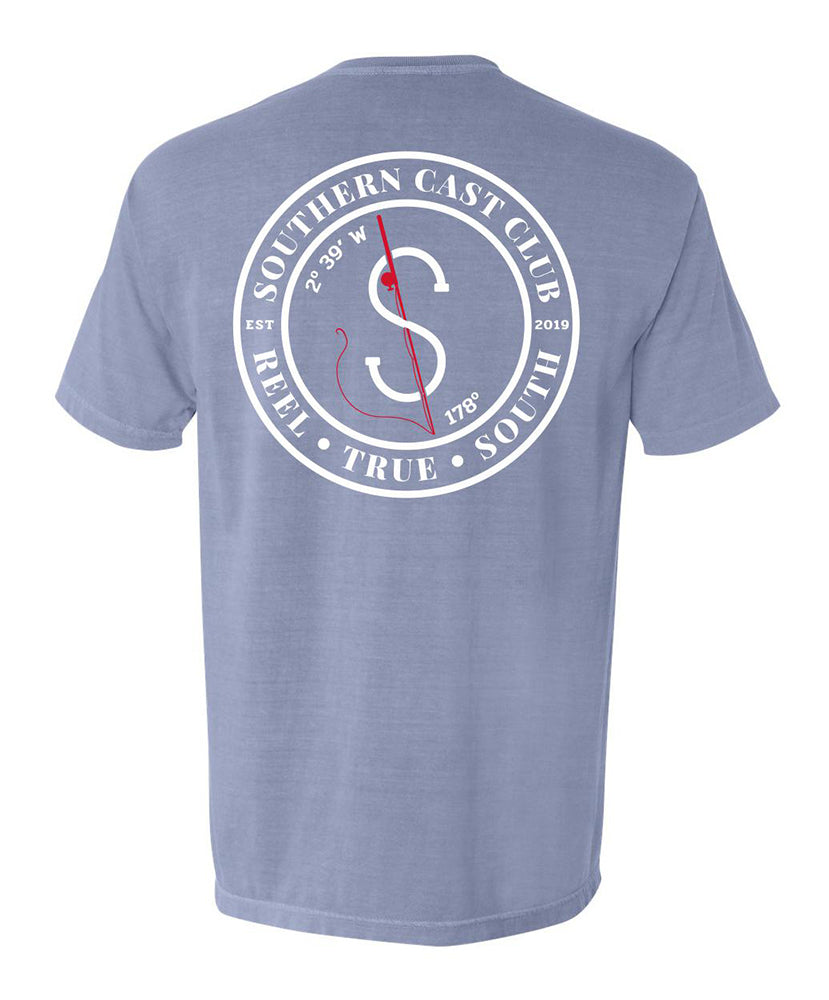 A heathered periwinkle blue short-sleeve t-shirt shown from the back, featuring a large white circular graphic with a red compass design and the text 'SOUTHERN CAST CLUB'.